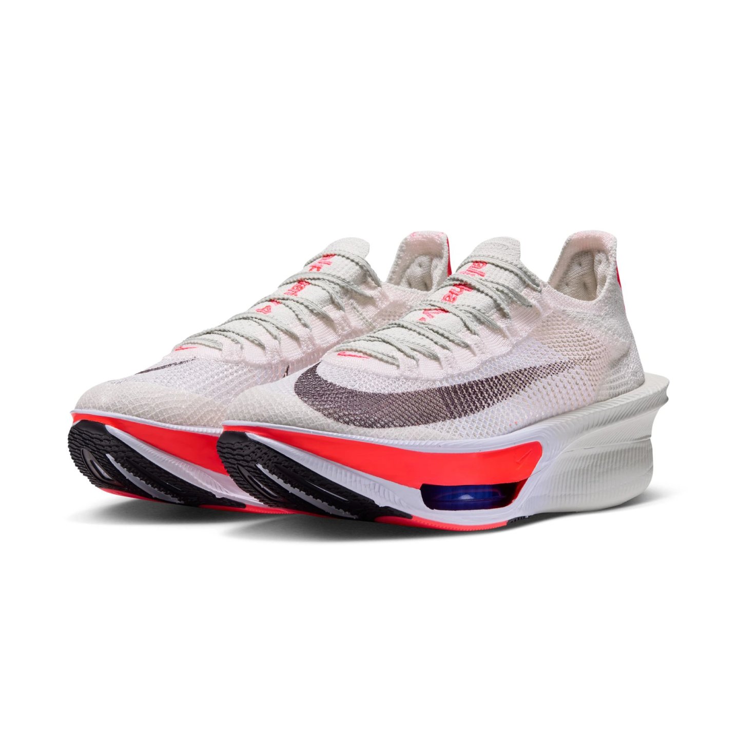 Pair of Nike Alphafly 4 running shoes in phantom white and bright crimson red, studio shot on white background