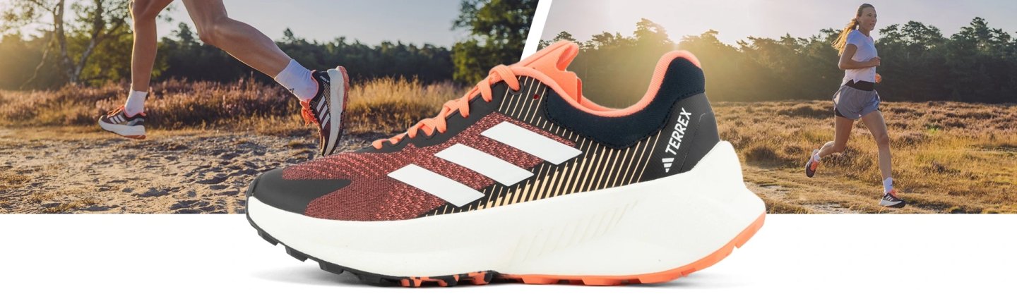 Adidas Terrex Soulstride trail running shoe in coral, black and white, shown on heathland trail at golden hour