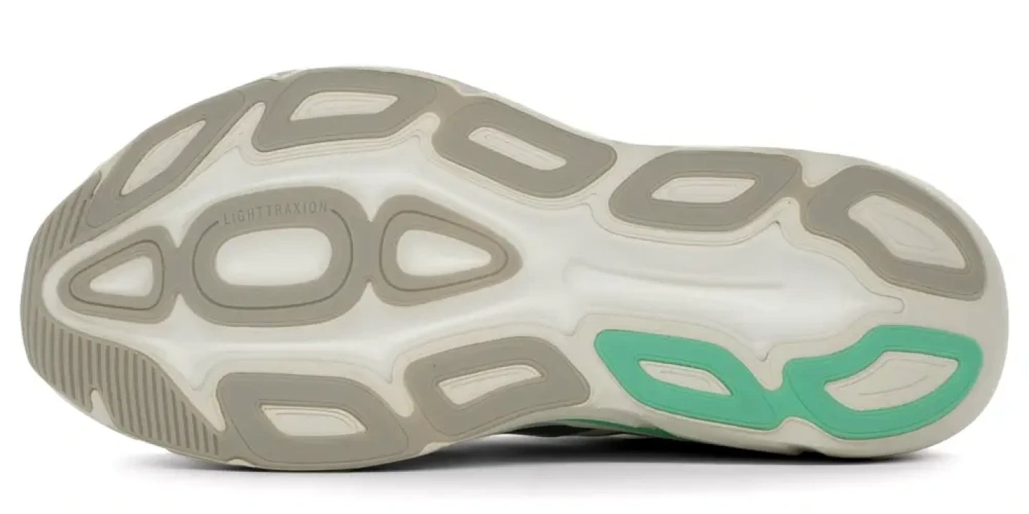 Bottom view of the Adidas Adistar BYD 2 running shoe outsole showing Light Traxion rubber lugs and teal heel accent