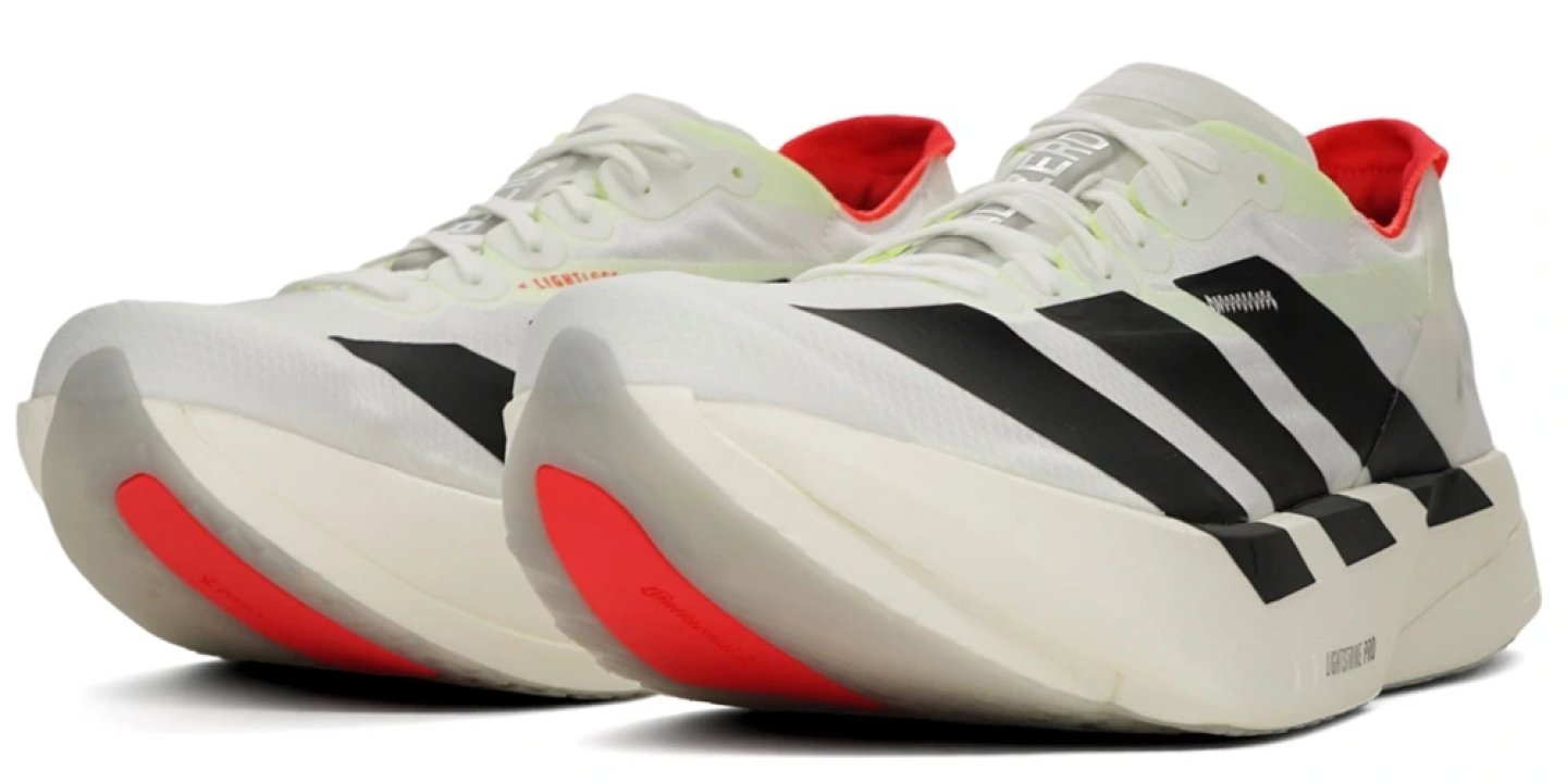 Adidas Adizero Adios Pro 4 running shoes in white, black and red, front three-quarter view showing Lightstrike Pro midsole