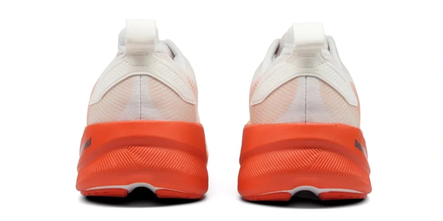 Rear view of Brooks Ghost Max 4 running shoes with white mesh upper and bold orange cushioned midsole