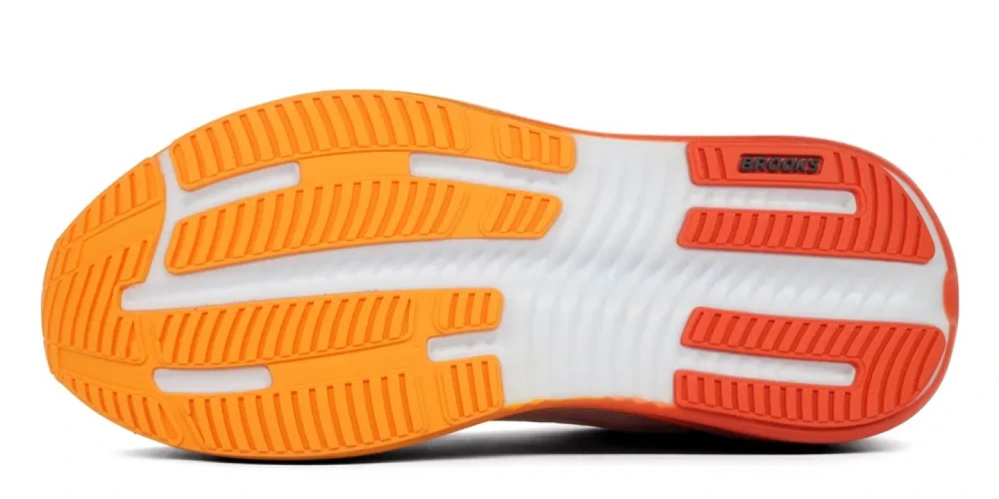 Bottom view of Brooks Ghost Max 4 running shoe outsole showing orange and red rubber zones with white midsole flex grooves