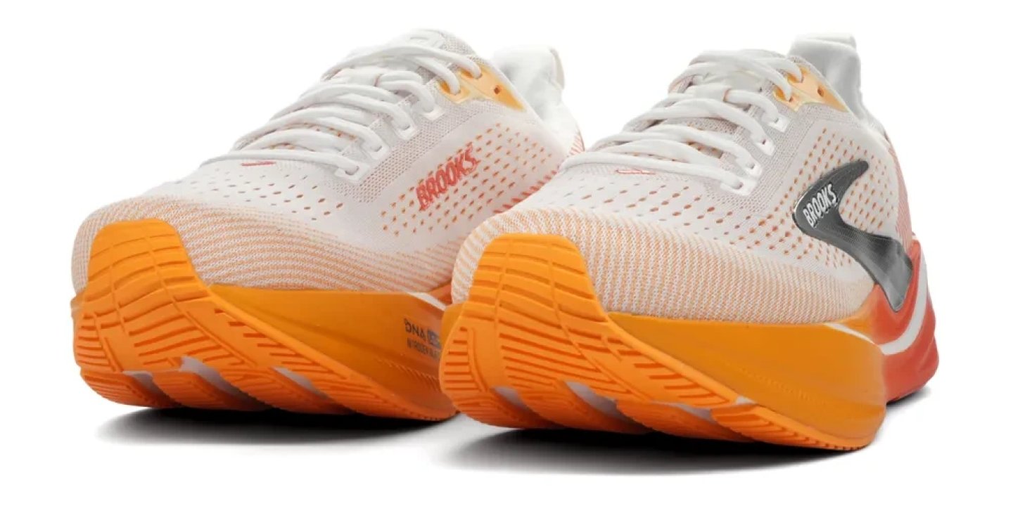Brooks Ghost Max 4 running shoes in white and orange, showing knit upper, DNA LOFT midsole and orange outsole, pair view