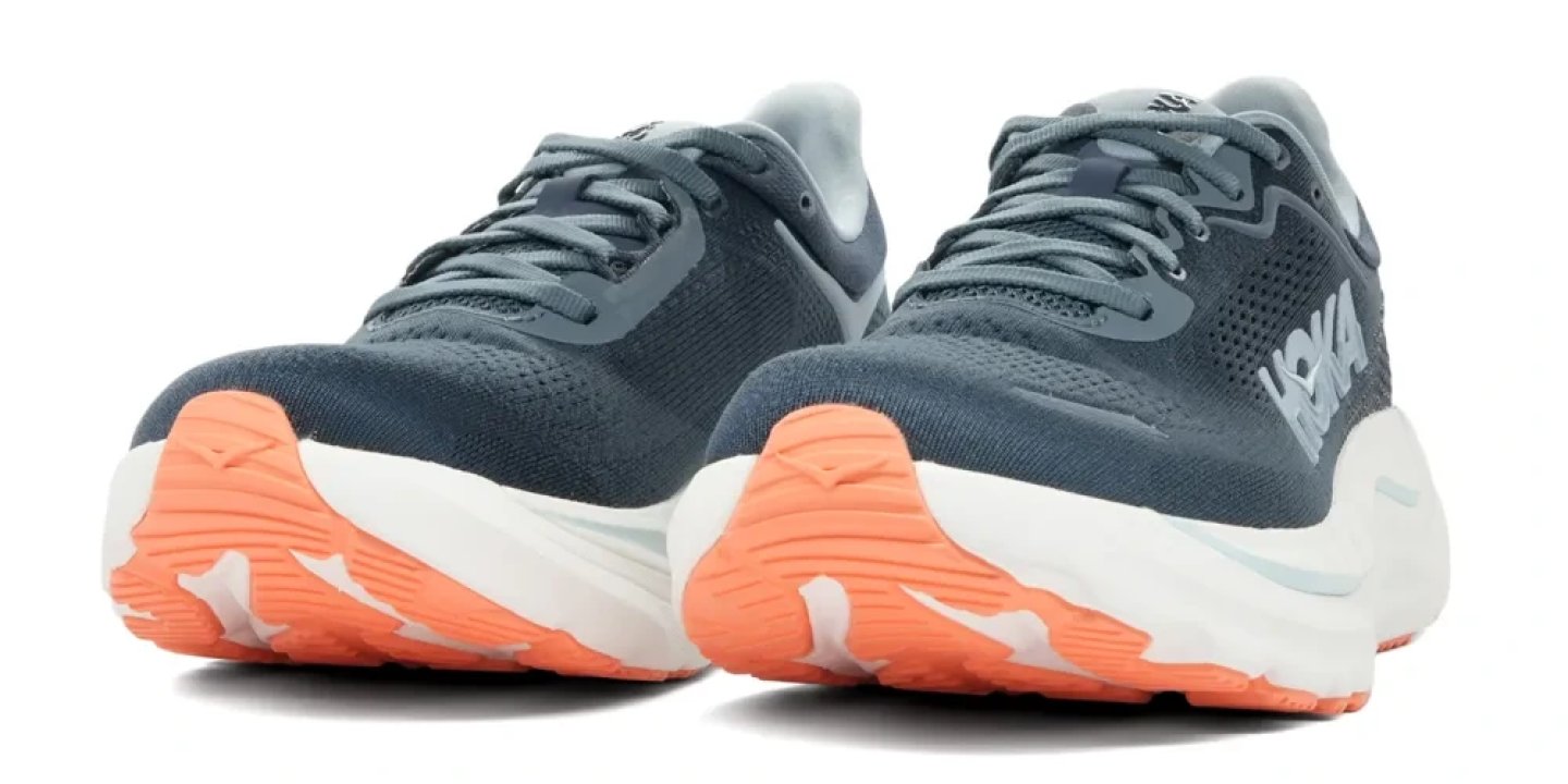 Hoka Arahi 9 running shoes in slate blue with coral orange outsole and white midsole, rear three-quarter view