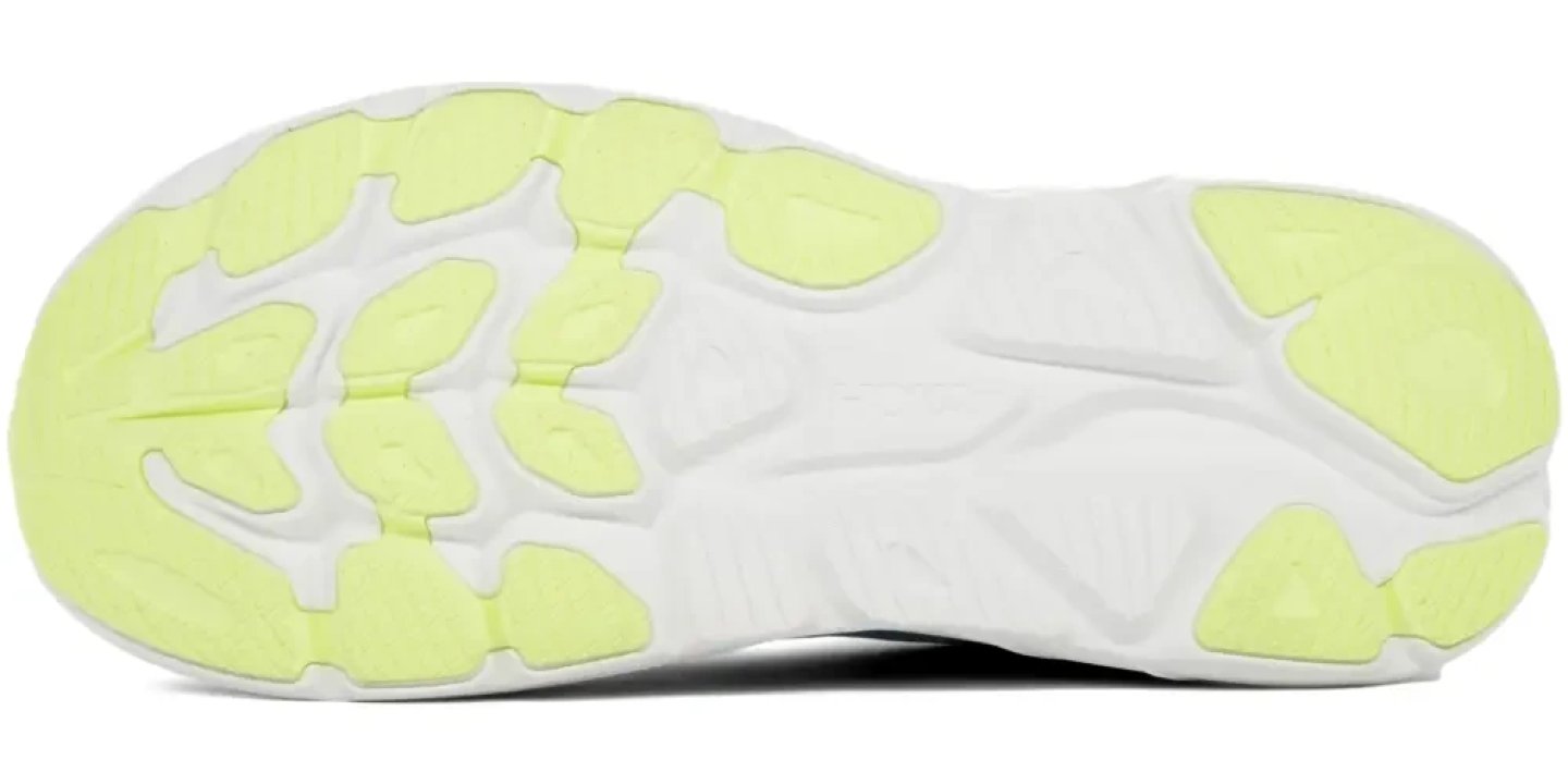 Bottom view of the Hoka Clifton 11 running shoe outsole showing lime yellow rubber lugs on a white base for traction