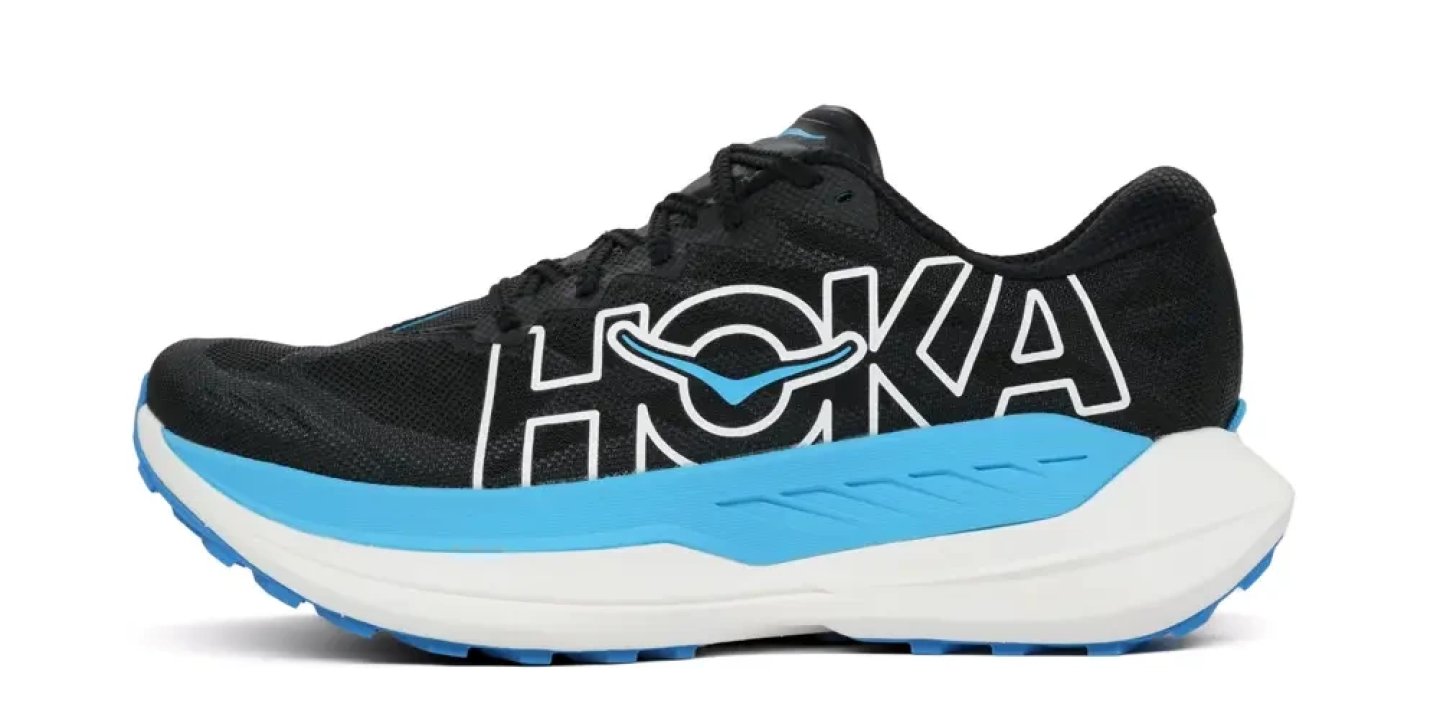 Hoka Rocket X Trail 4 running shoe in black and blue, lateral view showing oversized HOKA branding and thick midsole