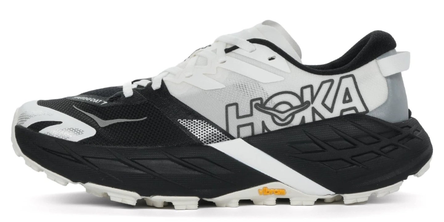 Hoka Speedgoat 7 trail running shoe in black and white colourway, lateral side view showing Vibram outsole
