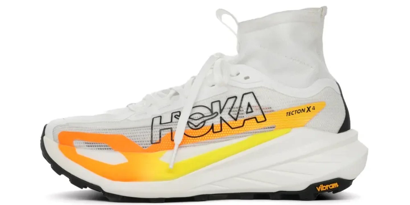 Hoka Tecton X 4 trail running shoe in white with orange and yellow gradient detailing and Vibram outsole, lateral view