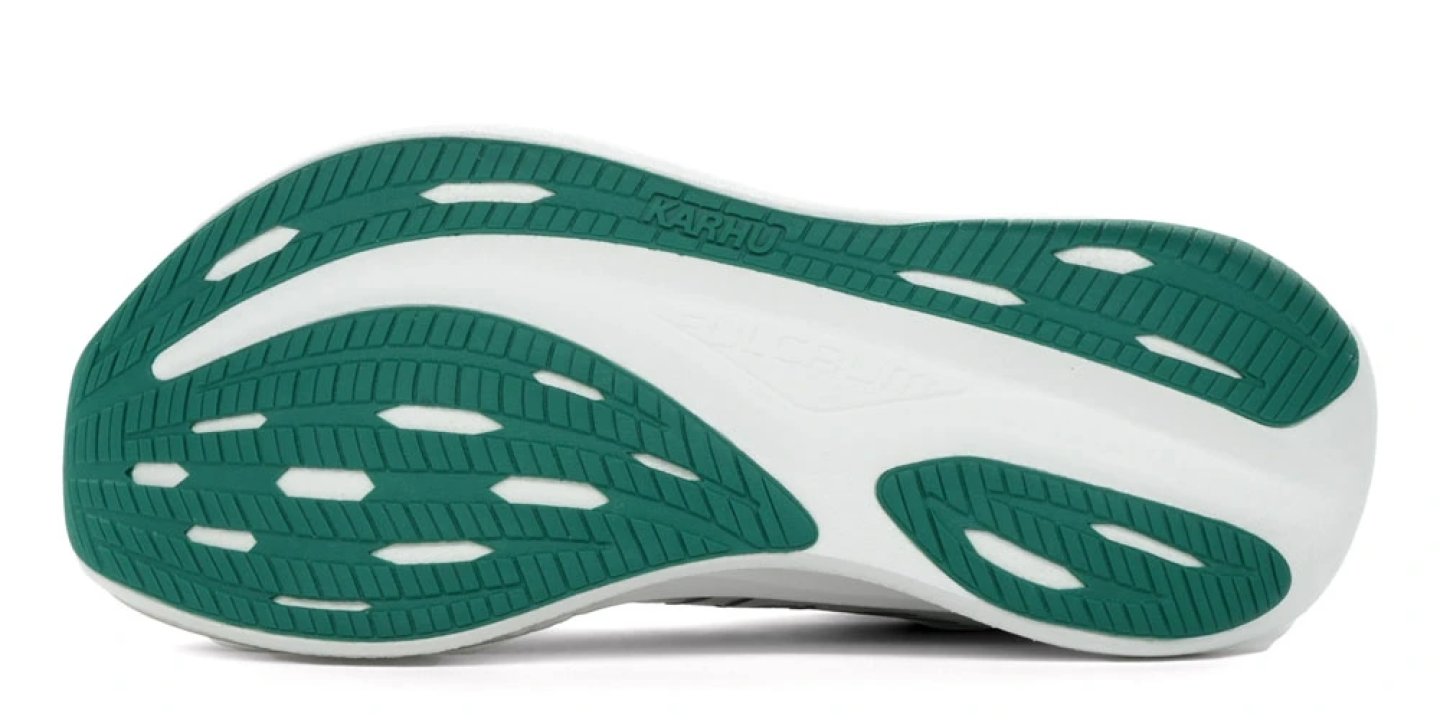 Bottom view of Karhu Fusion 5 running shoe outsole showing teal rubber traction zones and white midsole.