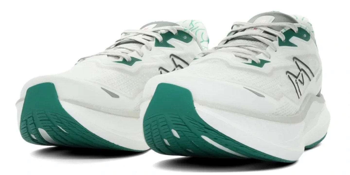 Pair of Karhu Fusion 5 running shoes in white and forest green, shown from a rear three-quarter angle