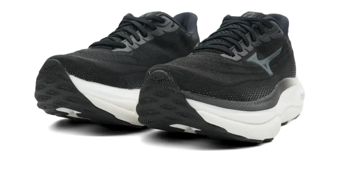 Pair of Mizuno Wave Sky 9 running shoes in black with white midsole, shown from a front three-quarter angle on white background.