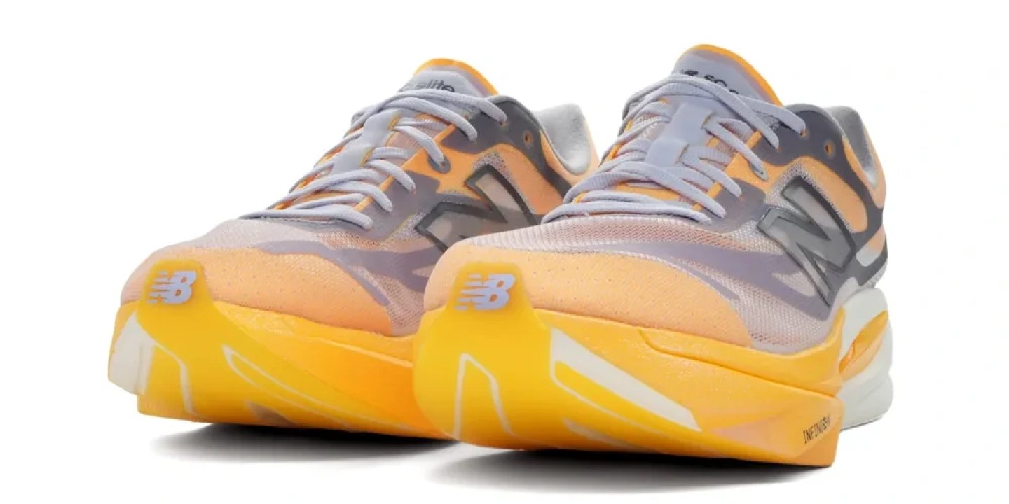 New Balance FuelCell SuperComp Elite v6 running shoes in orange and grey, rear three-quarter view showing stack height