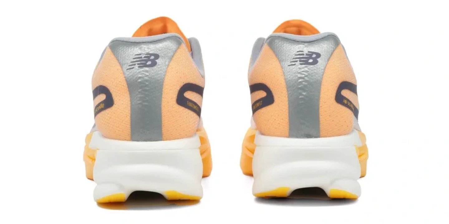 Rear view of New Balance FuelCell SuperComp Elite v6 running shoes in orange and silver with white midsole