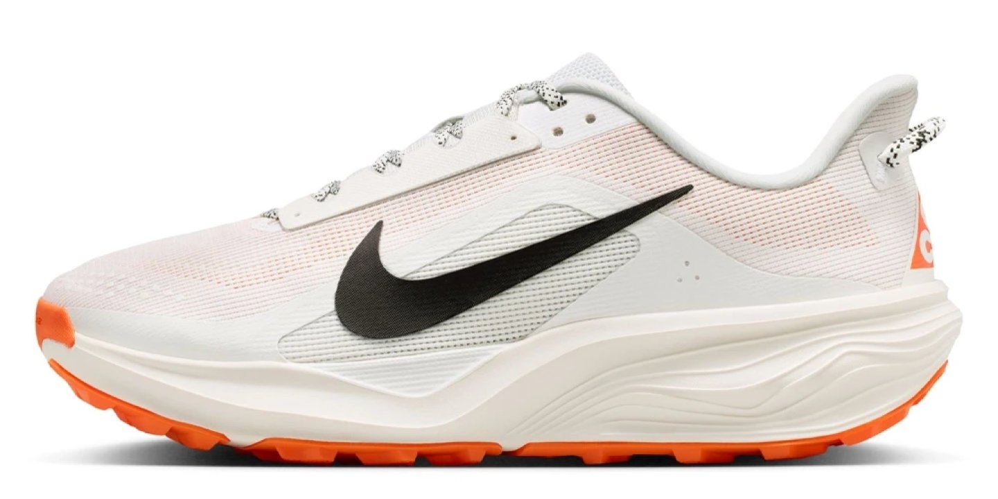 Nike ACG Pegasus Trail running shoe in white with black Swoosh and orange outsole, lateral side view