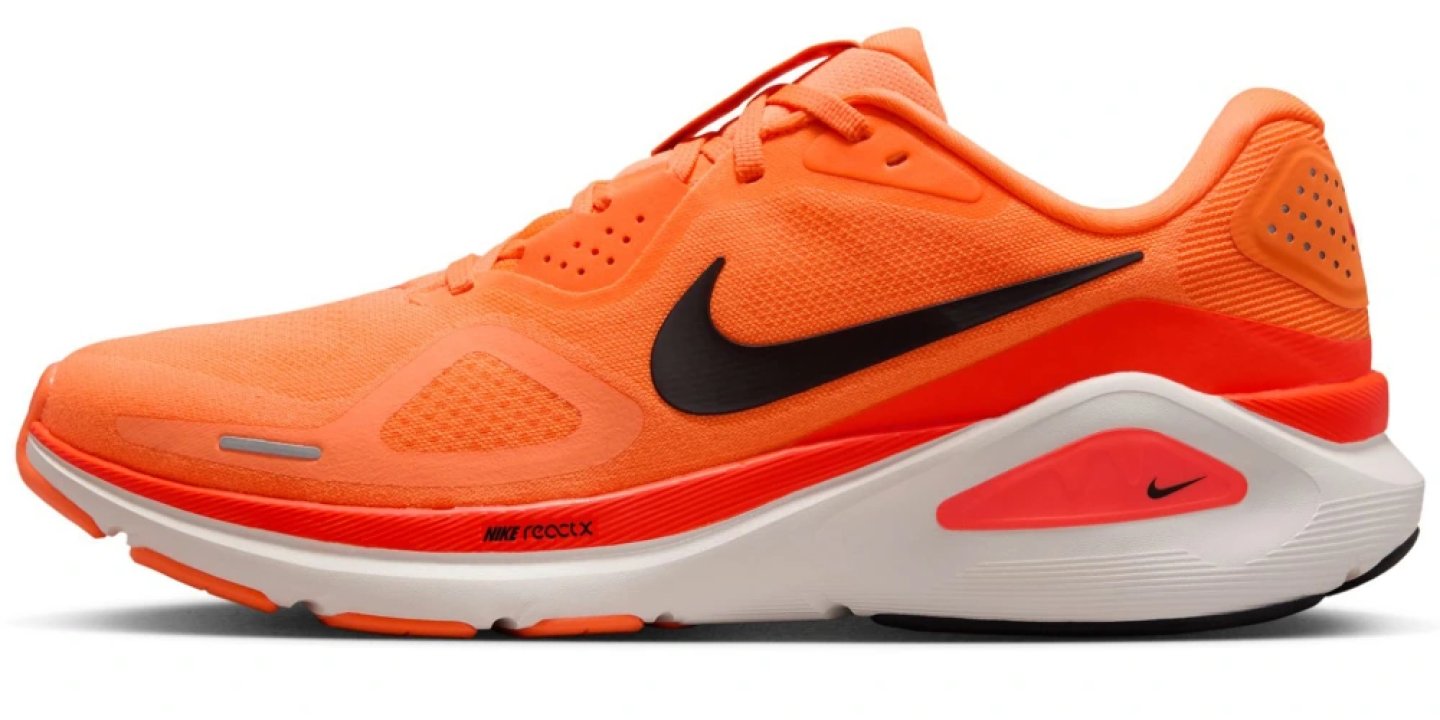 Nike Structure 26 running shoe in orange with black Swoosh, ReactX foam midsole, and red heel pod, lateral view