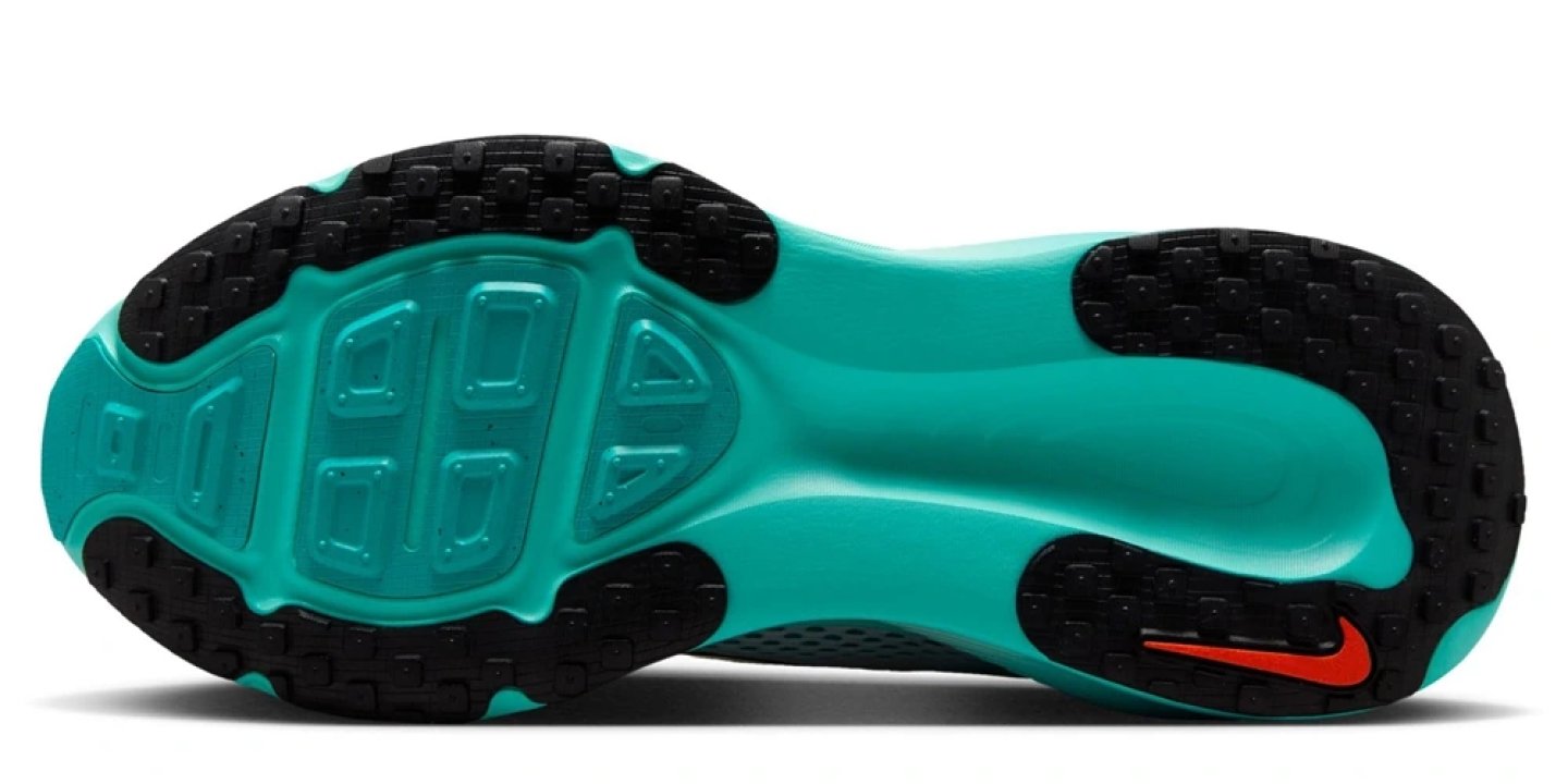 Bottom outsole view of Nike Vomero 18 running shoe in teal and black with rubber lug traction pattern