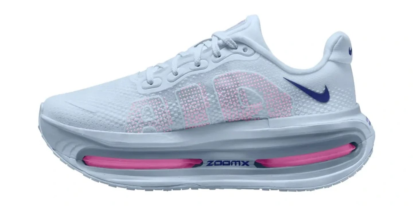 Nike Vomero Premium running shoe in white with pink ZoomX midsole unit and deep blue Swoosh, lateral view on white background.