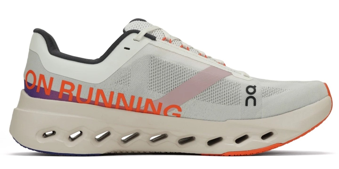 On Cloudsurfer Nex running shoe in white with orange On Running branding, purple accents, and signature CloudTec sole, medial view