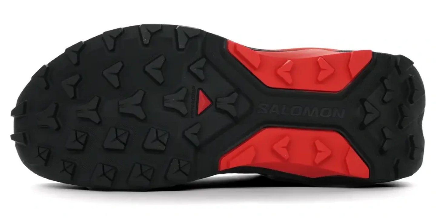 Bottom view of Salomon S/LAB Genesis 2 trail running shoe outsole with black and red multi-directional lug pattern