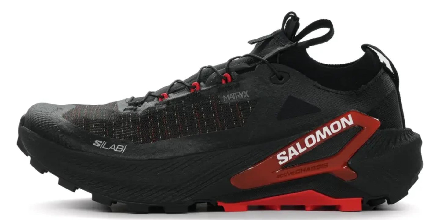 Salomon S/LAB Genesis 2 trail running shoe in black and red, lateral view showing Matryx upper and Active Chassis midsole