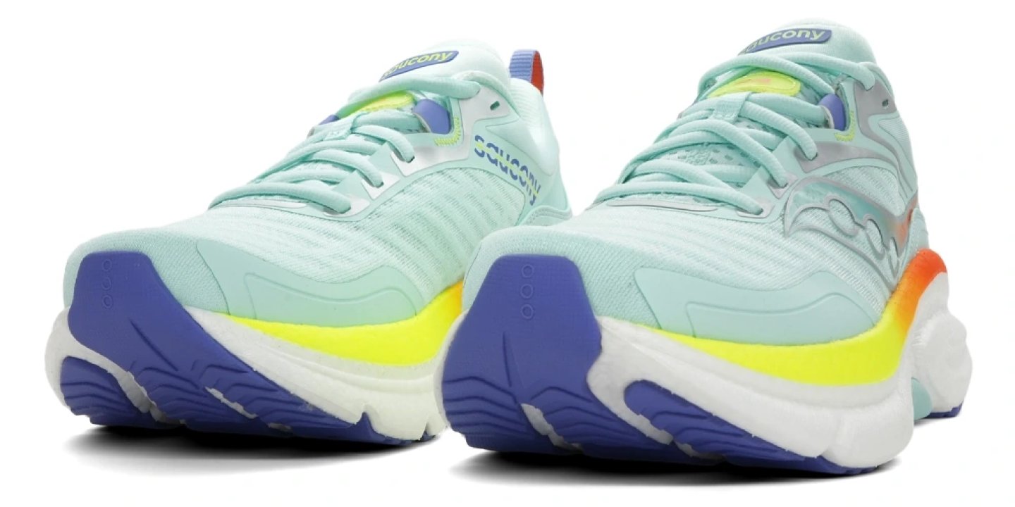 Saucony Omni 23 ST running shoes in mint green with purple and neon yellow midsole, front three-quarter view