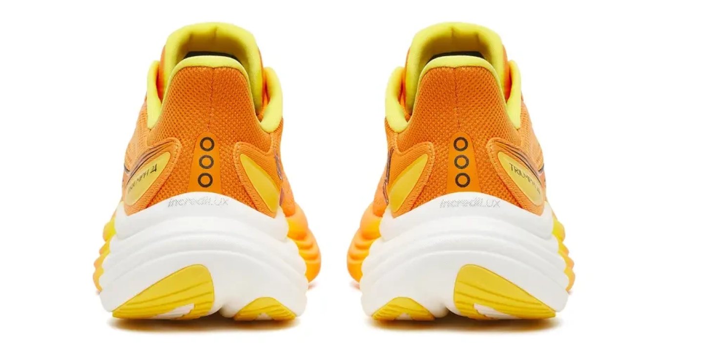 Rear view of a pair of Saucony Triumph 24 running shoes in orange and yellow with a white midsole