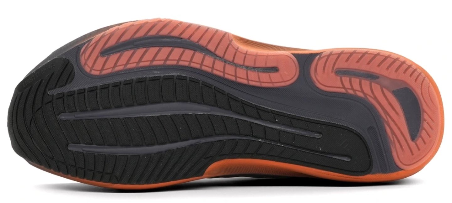 Bottom view of Adidas Supernova Solution 3 running shoe outsole showing black and terracotta rubber zones with flex grooves