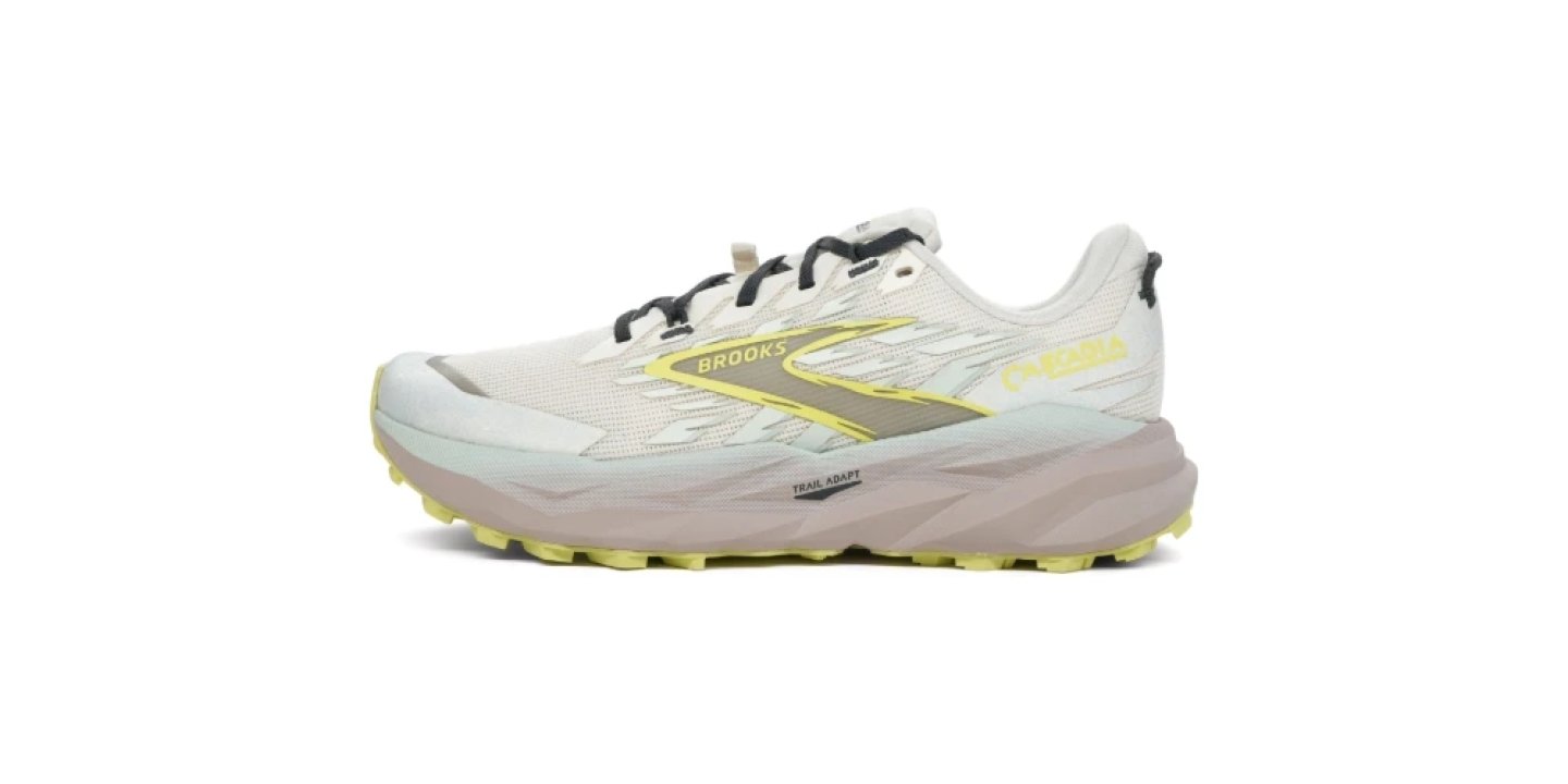 Brooks Cascadia trail running shoe in white and yellow with purple midsole and aggressive lugged outsole, side profile view