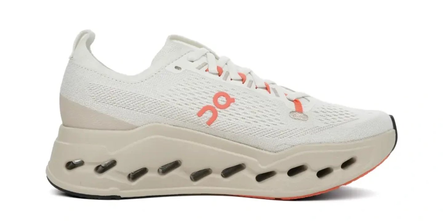 On Cloudsurfer Max 2 running shoe in white and coral, lateral view, featuring CloudTec midsole pods and knit upper