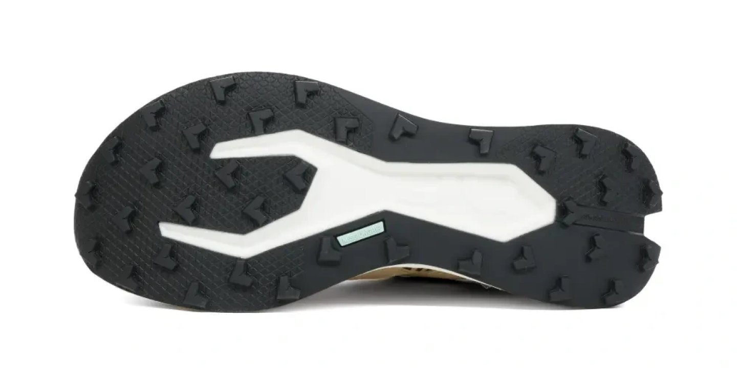 Bottom view of the On Cloudultra Pro 2 trail running shoe showing black rubber outsole with directional lugs and white midsole plate