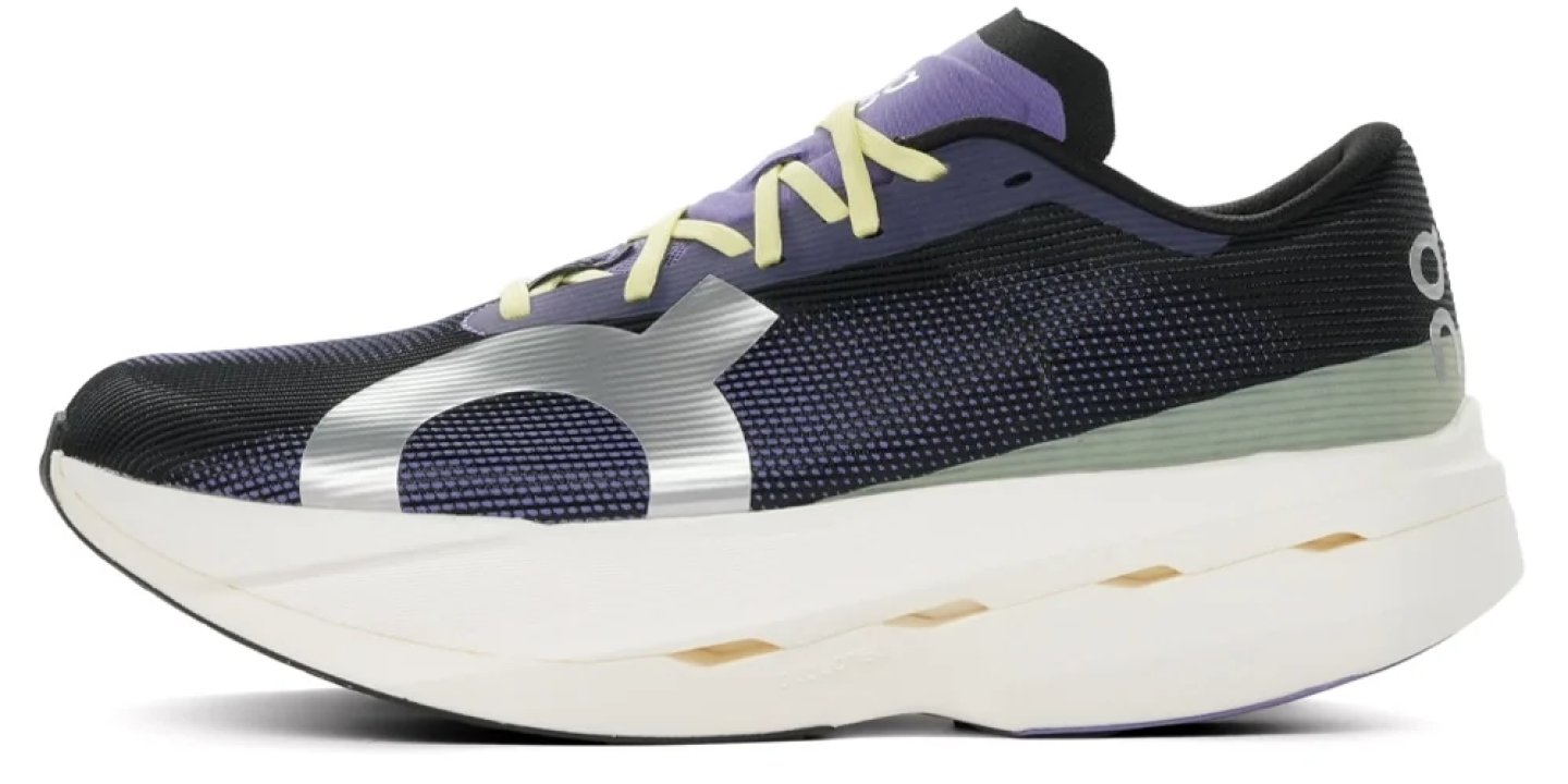 On running shoe in black mesh with purple collar, yellow laces, silver logo, and thick white foam midsole, lateral view.