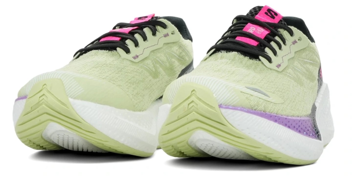Salomon Aero Glide 4 running shoes front view, lime green knit upper with black laces, purple and pink accents