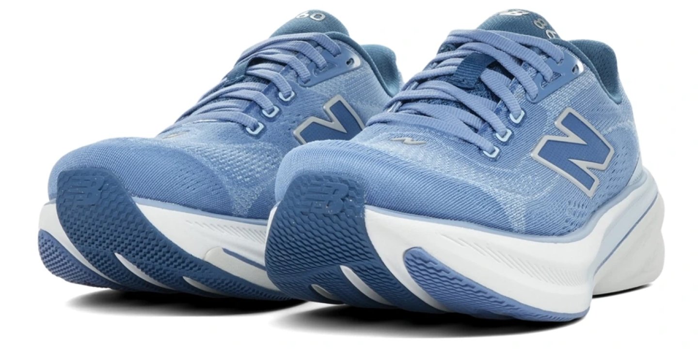 Pair of New Balance 860 v15 running shoes in steel blue with white midsole and dark blue outsole, rear three-quarter view