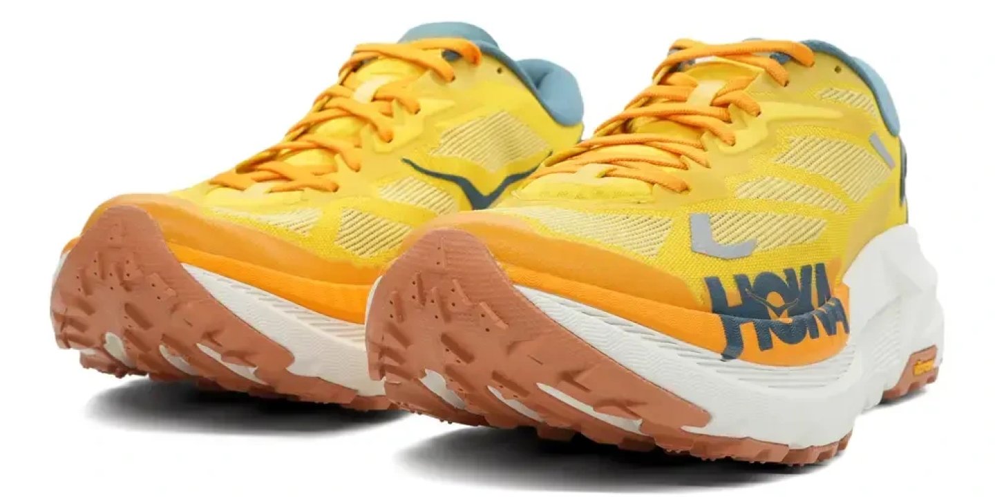 Pair of Hoka Mafate X trail running shoes in yellow and orange with white midsole and brown rubber outsole