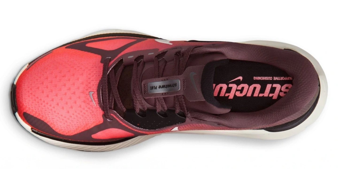 Top-down view of Nike Structure Plus women's running shoe in coral pink and burgundy colourway with white midsole