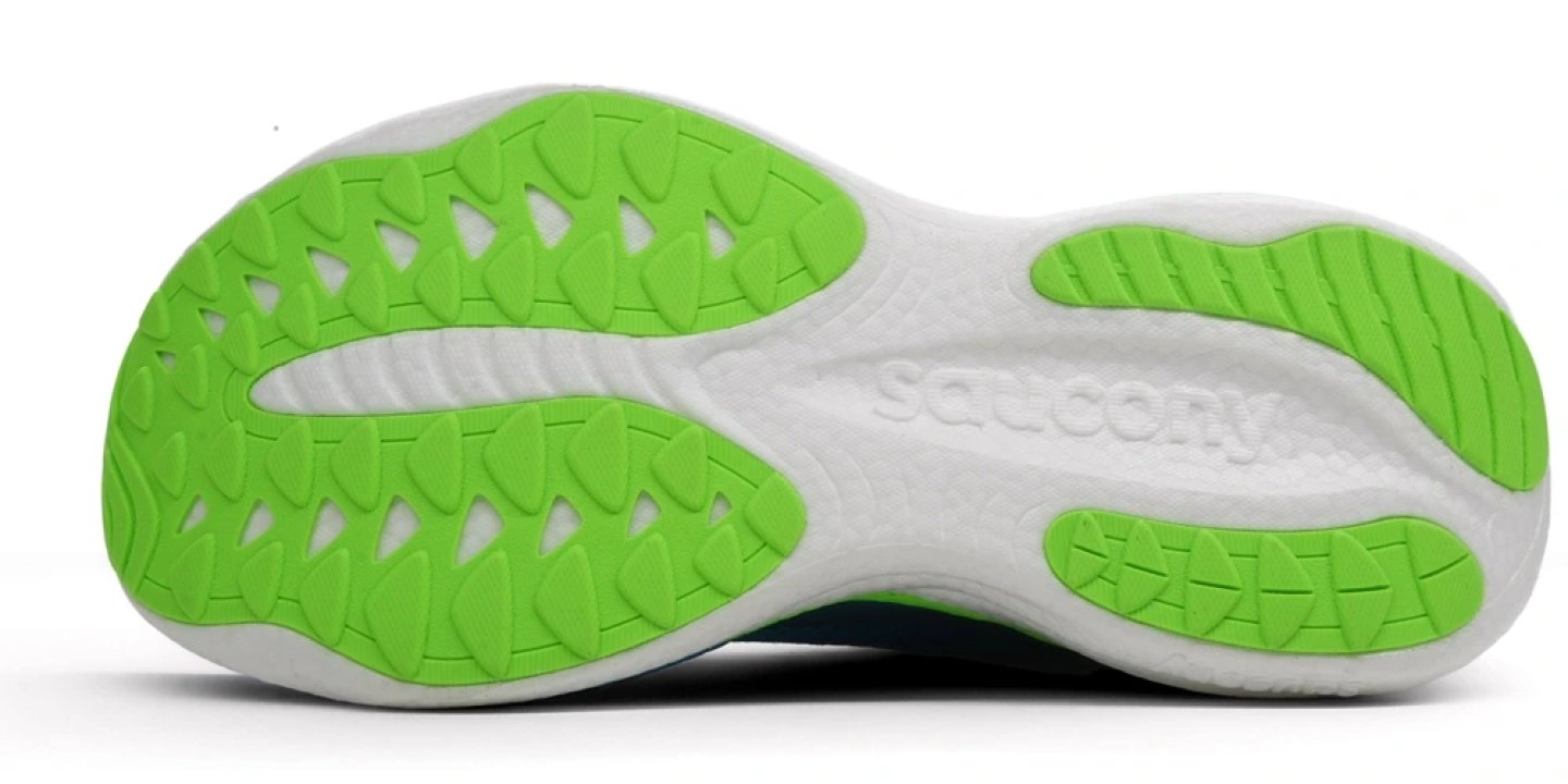 Bottom view of Saucony Ride 19 running shoe outsole with slime green rubber traction pods and white midsole