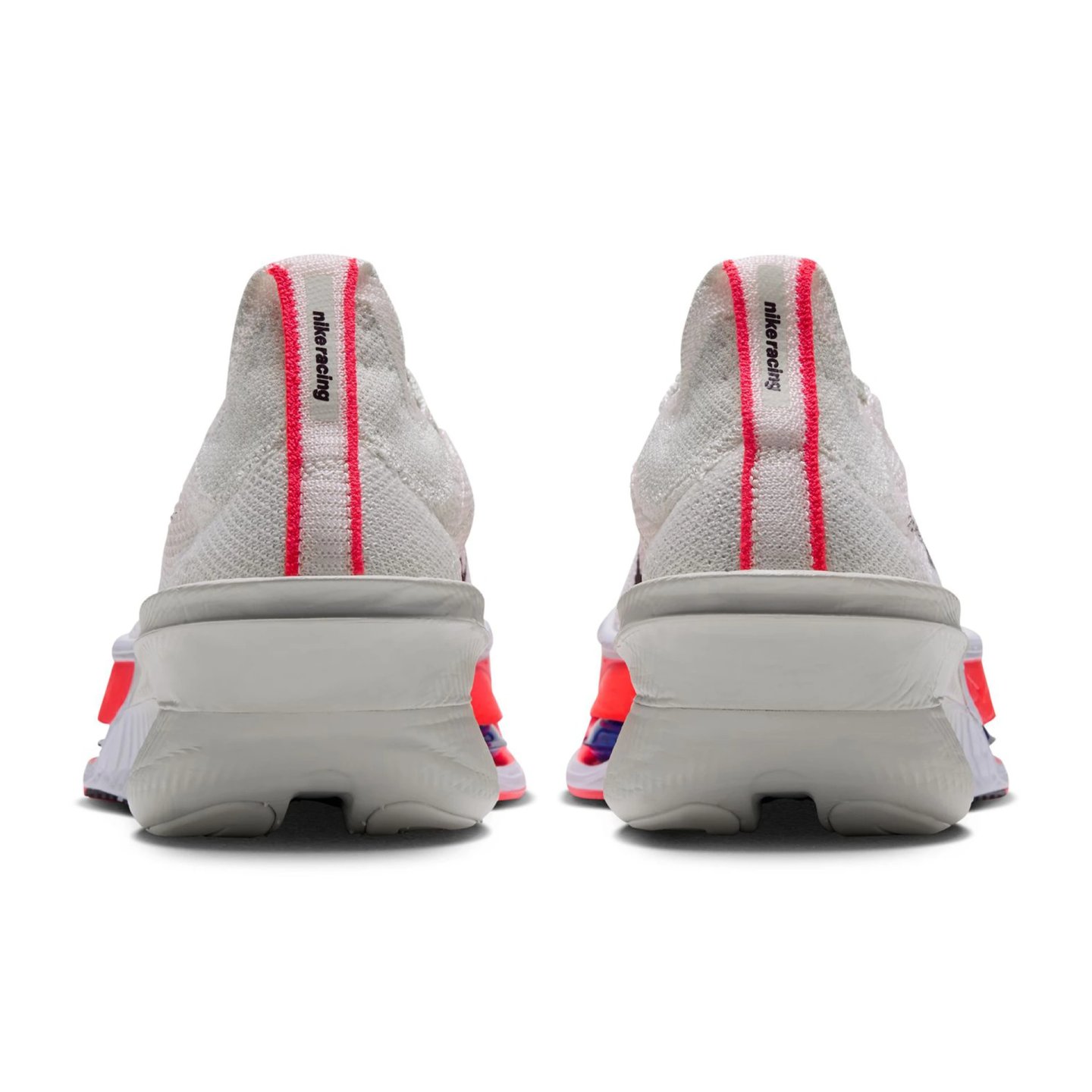 Rear view of both Nike Alphafly 4 running shoes showing white Flyknit upper, red heel stripe, Nike Racing text, and bright midsole.
