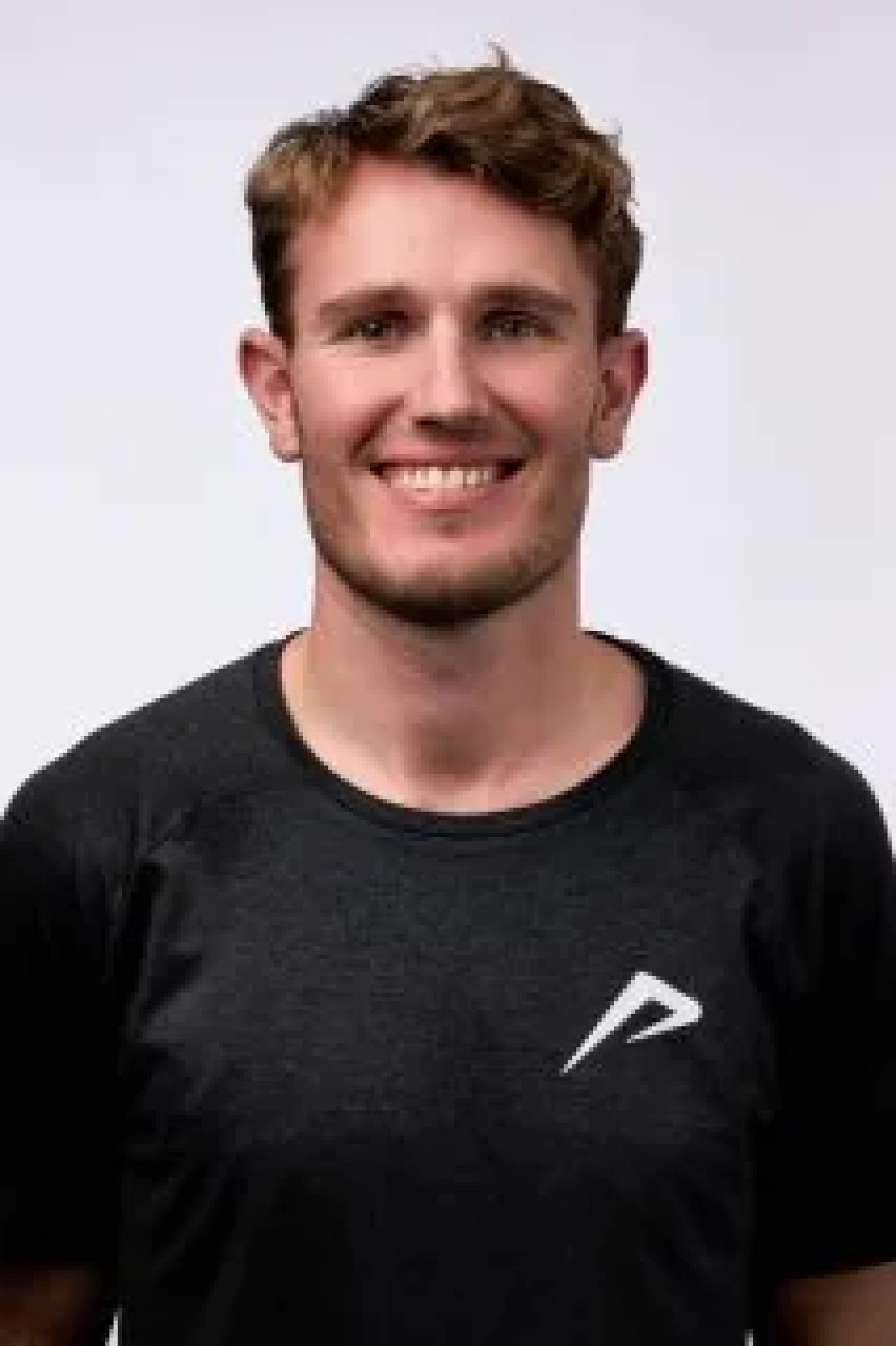 Headshot portrait of Stride athlete Menno Munster in a black Stride t-shirt against a white background.