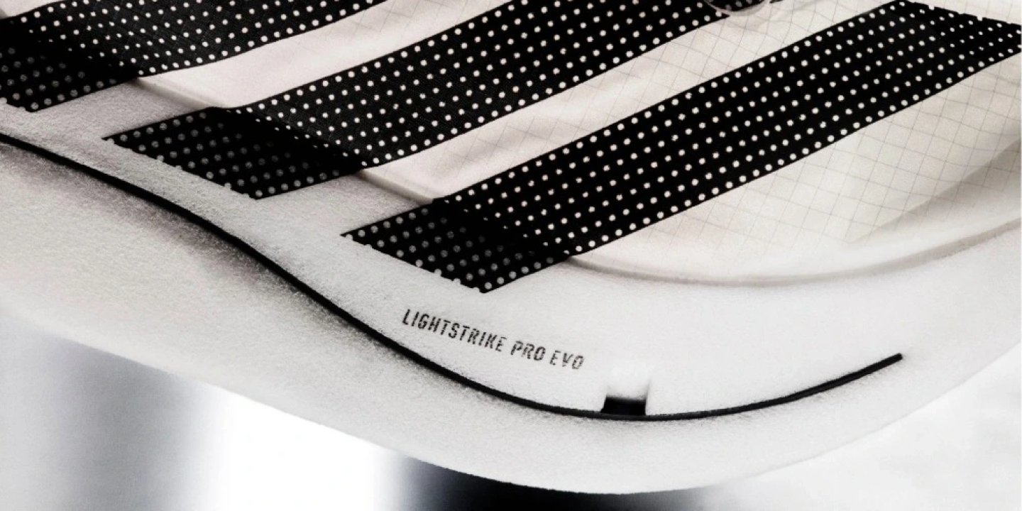 Close-up of Adidas Adizero Adios Pro Evo 3 midsole showing LightStrike Pro EVO foam with three-stripe overlay detail