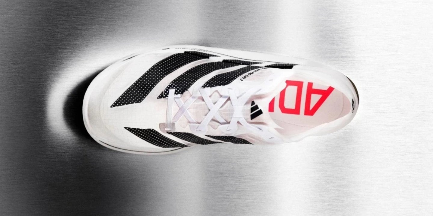 Top-down view of the Adidas Adizero Adios Pro Evo 3 in white and black with red Adidas branding on the insole