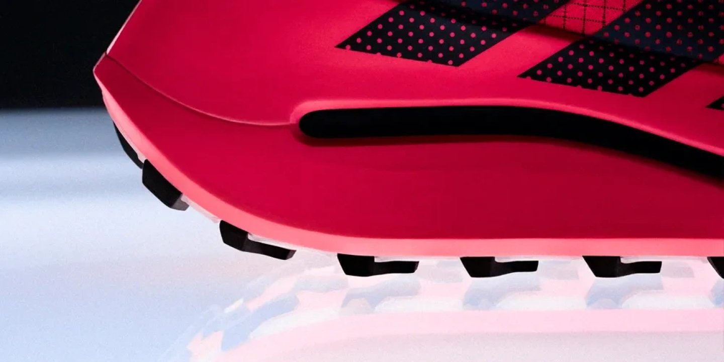 Close-up detail of the Adidas Terrex Agravic Evo trail running shoe outsole with black rubber lugs and pink midsole