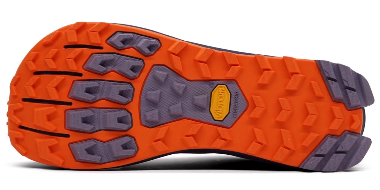 Bottom view of Altra Lone Peak 9+ trail running shoe outsole showing orange Vibram Megagrip rubber with purple multidirectional lugs