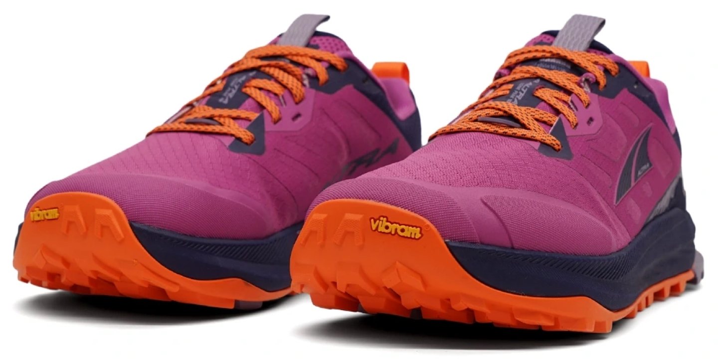 Altra Lone Peak 9+ women's trail running shoe in pink and purple with orange Vibram outsole, angled front view