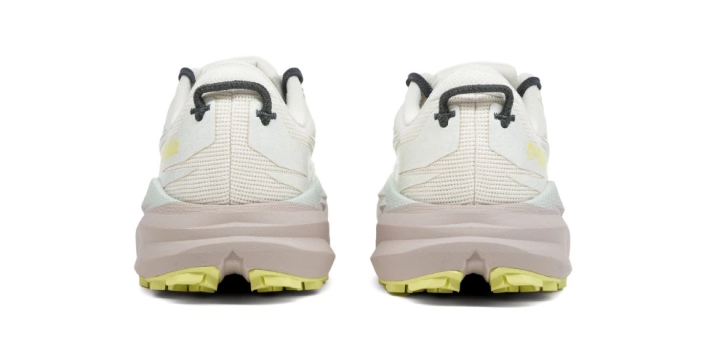 Rear view of a pair of Brooks Cascadia 19 trail running shoes in white with a pink midsole and yellow-green outsole