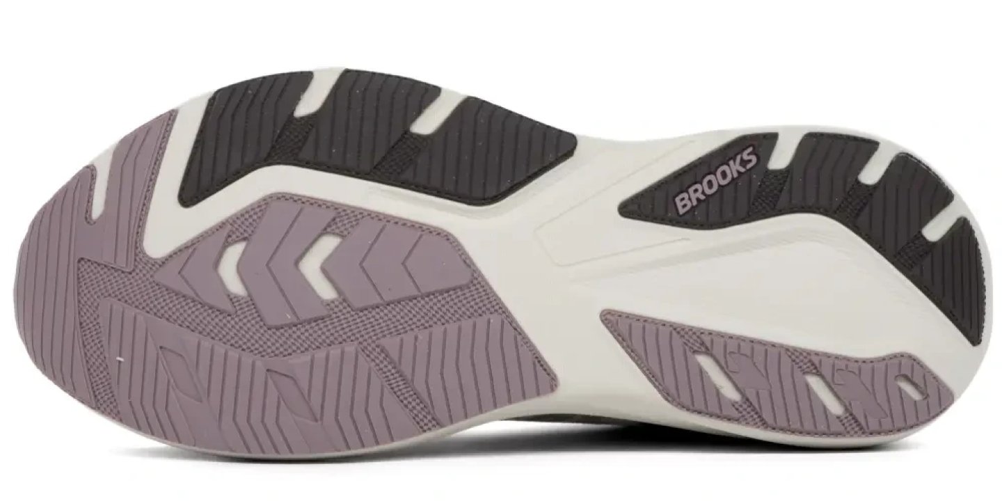 Bottom view of the Brooks Ghost AMP running shoe outsole showing purple, black and white rubber traction zones and flex grooves.