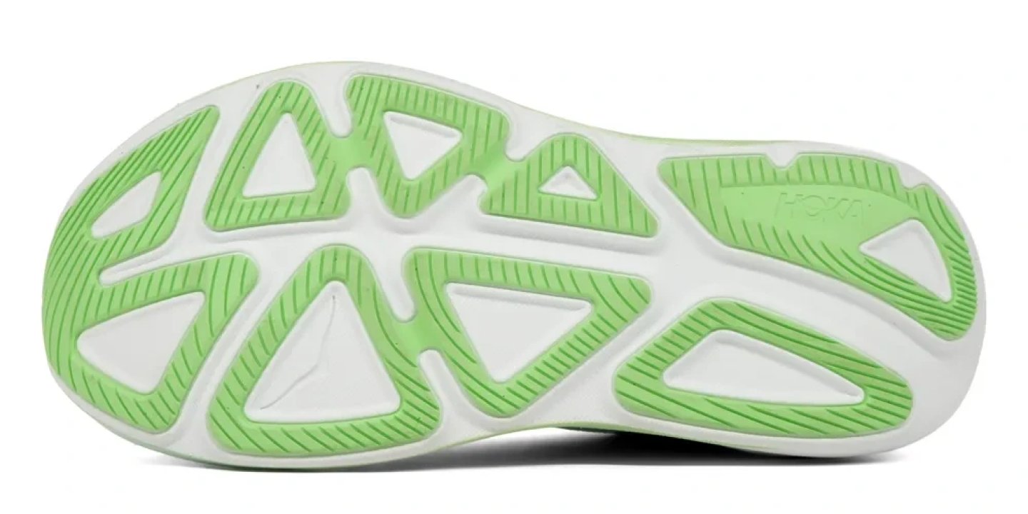Bottom view of Hoka Clifton Pro running shoe outsole with green triangular rubber traction lugs on white base