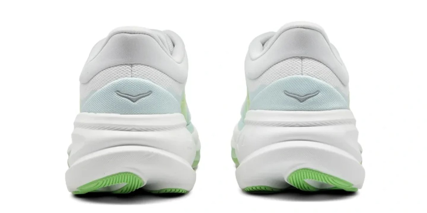 Rear view of Hoka Clifton Pro running shoes in white and light blue with bright green outsole accents