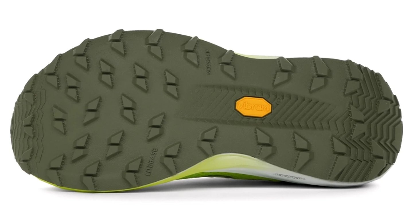 Bottom view of New Balance SC Trail v2 trail running shoe outsole showing Vibram Megagrip rubber with multi-directional lugs