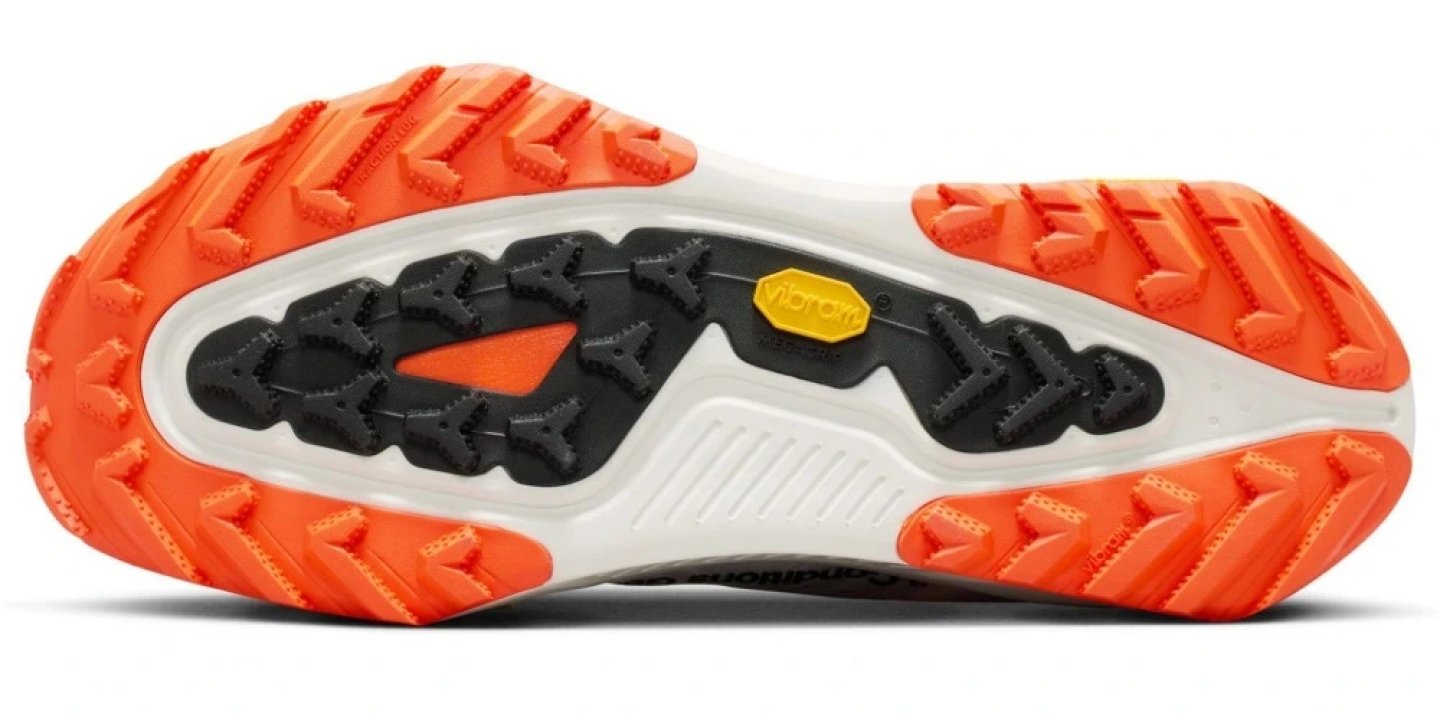 Bottom view of Nike ACG Zegama trail running shoe outsole with orange Vibram lugs and black central traction zone