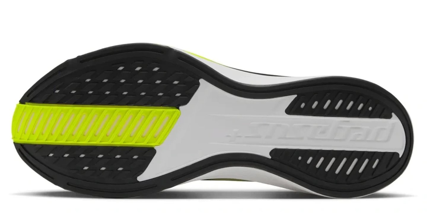 Bottom view of Nike Pegasus Plus 2 running shoe outsole with black rubber lugs, white midsole and volt yellow foam strip